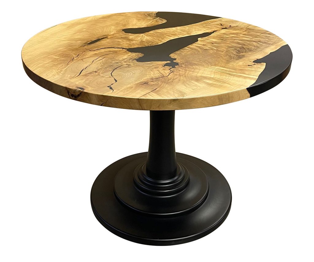 Single Pedestal Table, maple live edge top with a black epoxy pour. Mounted on a painted black pedestal.