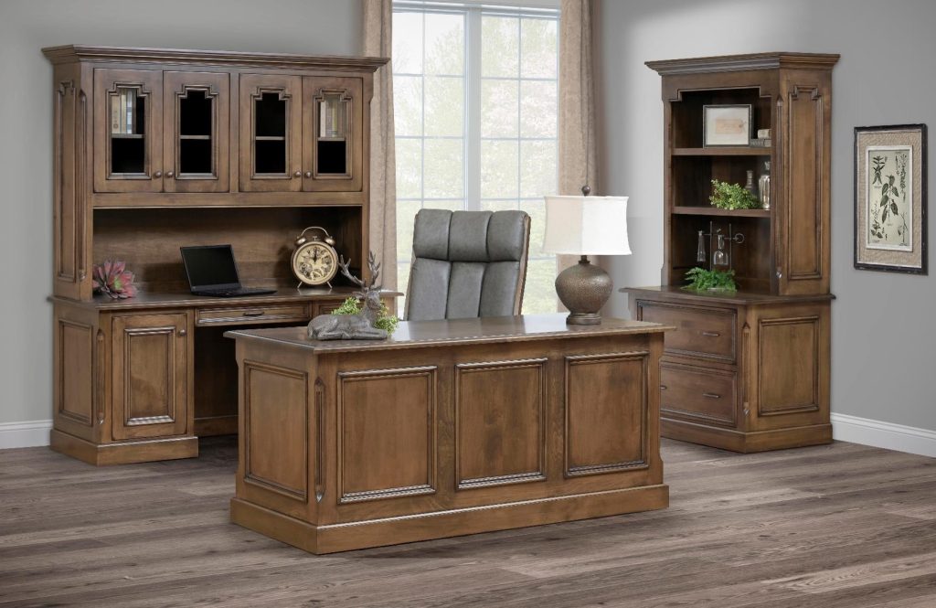 Office furniture with subtle European accents. Shown in Cherry with light beige stain called Stockton. Here you see an Executive Desk, Cradenza with Hutch top, Lateral File Cabinet with Bookcase, and the desk chair with leather upholstery.