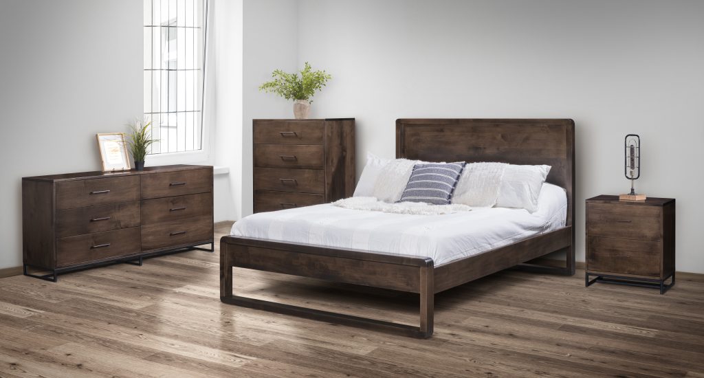 A room scene of the modern and minimalist Sherbrooke bedroom set. Shown in solid maple wood with a dark brown stain.