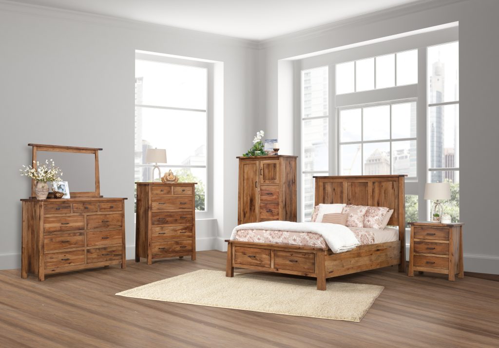 Gold Rush bedroom suite with a bed, 3 drawer nightstand, man's chest, chest of drawers, and 9 drawer dresser with mirror. Shown in rustic hickory with a light brown stain and black drawer pulls.